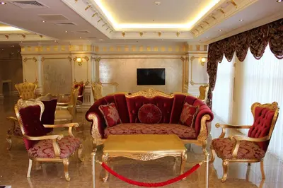 a living room with a red couch and chairs at World Point Hotel Istanbul in Istanbul
