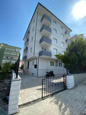 a large white building with a fence in front of it at ANA GÜNEY Apart Otel in Nilüfer