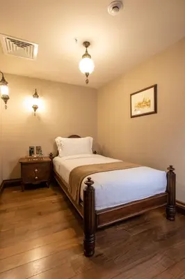 a bedroom with a bed and a night stand and lights at AJWA Sultanahmet - Preferred Hotels LVX Collection in Istanbul