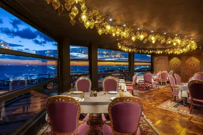 a dining room with a table and chairs and large windows at AJWA Sultanahmet - Preferred Hotels LVX Collection in Istanbul