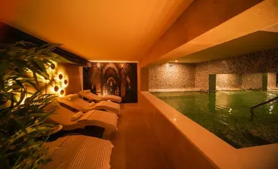 a large swimming pool with couches in a building at Almira Hotel Thermal Spa & Convention Center in Bursa