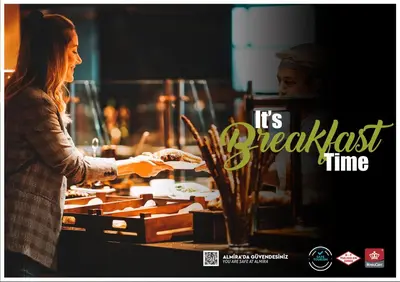 a woman is preparing food in a kitchen at Almira Hotel Thermal Spa & Convention Center in Bursa