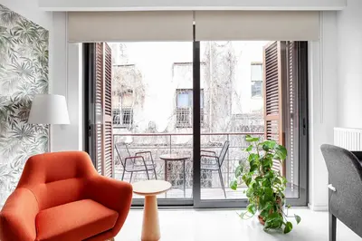 a living room with an orange chair and a balcony at NOA - Ali Hoca 6 in Istanbul