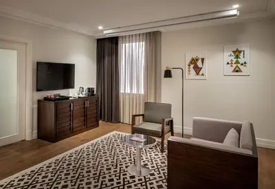 a living room with a couch and a tv at The Stay Boulevard Nisantasi in Istanbul