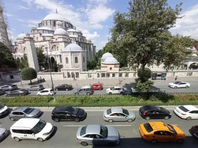 a parking lot with cars in front of a building at Emin Konak Hotel in Istanbul