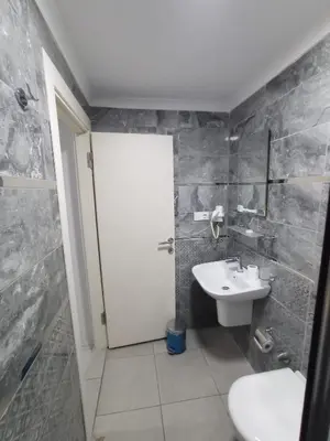 a bathroom with a white door and a sink at Emin Konak Hotel in Istanbul