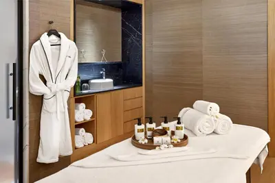 a bathroom with a sink and a table with towels at Vakko Hotel and Residence in Istanbul
