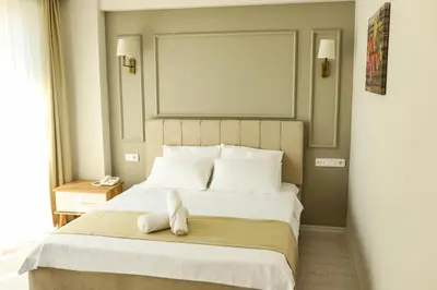 a bedroom with a bed with a stuffed animal on it at PETRA HOTEL TUZLA in Tuzla