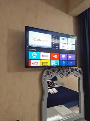 a flat screen tv hanging on a wall at BALPETEK HOTEL in Istanbul