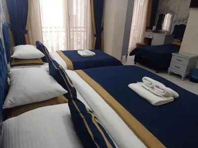a bedroom with two beds with towels on them at BALPETEK HOTEL in Istanbul