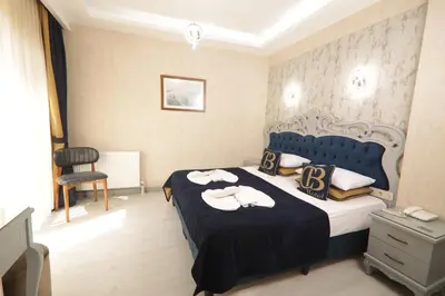 a bedroom with a bed with two swans on it at BALPETEK HOTEL in Istanbul