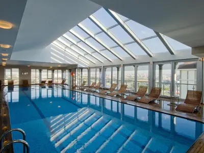 a large swimming pool with chairs in a building at WOW Istanbul Hotel in Istanbul