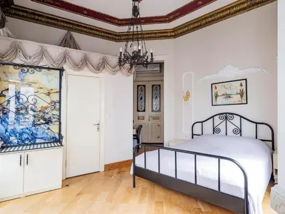 a bedroom with a bed and a painting on the wall at Ragip Pasha Apartments in Istanbul