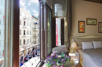 a room with a bed and a window with a view at Ragip Pasha Apartments in Istanbul