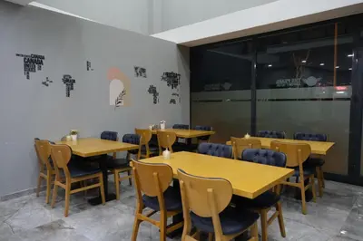a dining room with wooden tables and chairs at The Pearl Airport Hotel in Arnavutköy