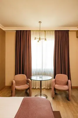 a room with two chairs and a table and a window at WOW Airport Hotel in Istanbul
