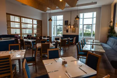 a restaurant with tables and chairs and windows at WOW Airport Hotel in Istanbul