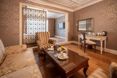 a living room with a couch and a table at The Central Palace Taksim in Istanbul