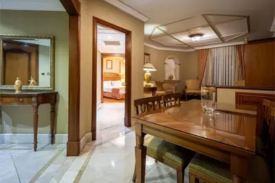 a dining room with a table and a bedroom at The Central Palace Taksim in Istanbul