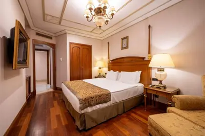 a hotel room with a bed and a couch at The Central Palace Taksim in Istanbul
