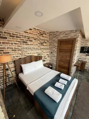 a bed in a room with a brick wall at La Vien Hotel Old City in Istanbul