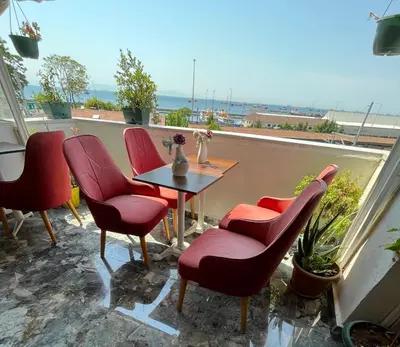 a table and chairs on a balcony with a view of the ocean at La Vien Hotel Old City in Istanbul