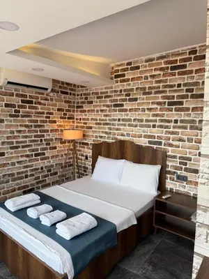 a room with a bed with a brick wall at La Vien Hotel Old City in Istanbul