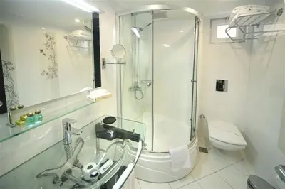 a bathroom with a shower and a sink and a toilet at Cartoon Hotel in Istanbul