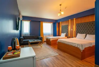 a hotel room with two beds and a couch at Royal Nest in Istanbul