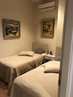 a room with three beds and a painting on the wall at Bursa Park Apart Hotel in Bursa