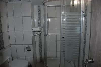 a small bathroom with a shower and a toilet at Bursa Park Apart Hotel in Bursa
