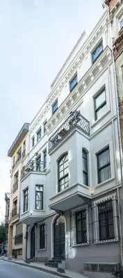 a white building on the corner of a street at Nm Suites Beyoglu in Istanbul