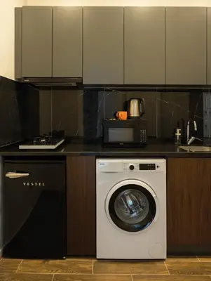a kitchen with a washing machine in a kitchen at Nm Suites Beyoglu in Istanbul