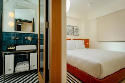 a hotel room with a bed and a mirror at The Gift Hotel in Istanbul