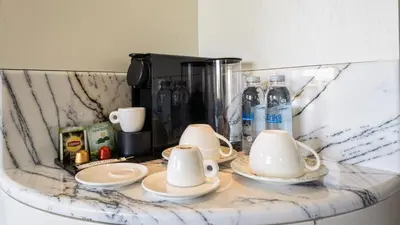 a marble counter top with cups and plates on it at The Gift Hotel in Istanbul
