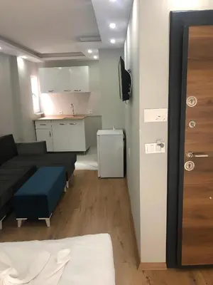 a living room with a couch and a kitchen at BLUE ROYAL HOTEL in Istanbul