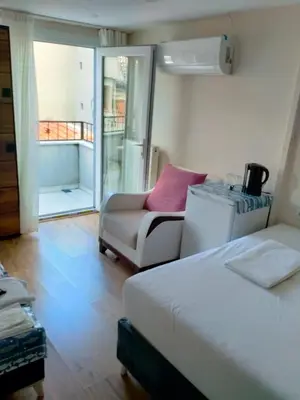 a bedroom with a bed and a couch and a chair at BLUE ROYAL HOTEL in Istanbul