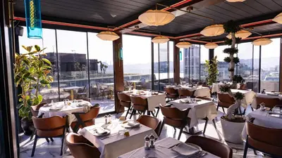 a restaurant with white tables and chairs and windows at Hotel De Reve Galata-Special Class in Istanbul