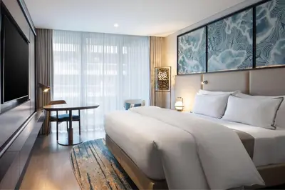 a hotel room with a large bed and a table at The Westin Istanbul Nisantasi in Istanbul