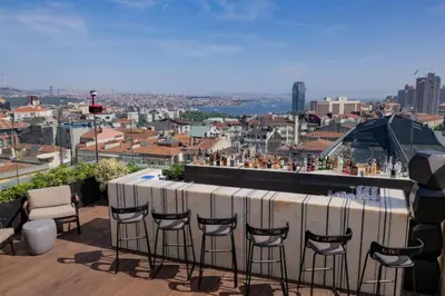 a bar on the roof of a building with stools at The Westin Istanbul Nisantasi in Istanbul
