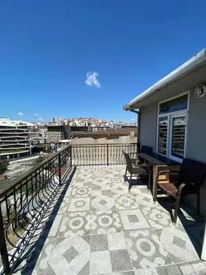 a balcony with chairs and a view of a city at Zelya Istanbul Flats in Istanbul