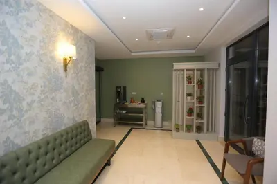 a living room with a green couch and a table at HaciBayramHotel in Istanbul