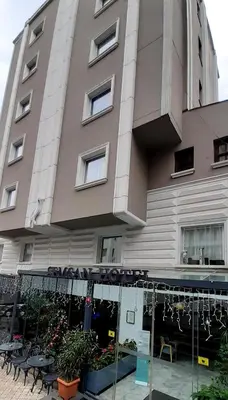 a building with tables and chairs in front of it at Semsan Hotel in Istanbul