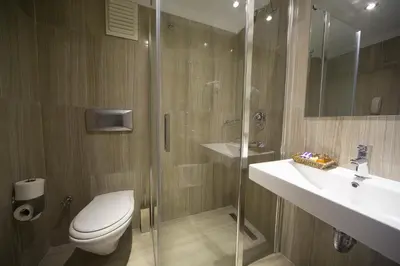 a bathroom with a toilet and a sink and a shower at Semsan Hotel in Istanbul