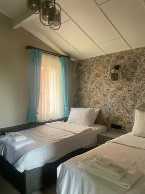 a room with two beds and a window at Noya Köşk Otel in Adalar
