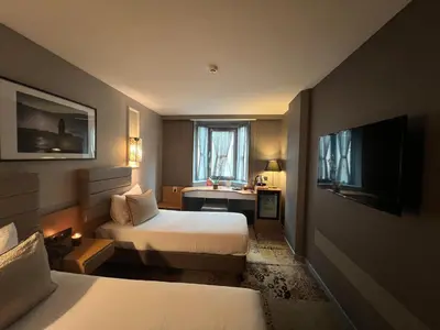 a hotel room with two beds and a television at All Seasons Hotel in Istanbul