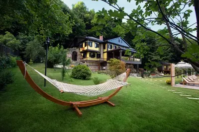 a hammock in a yard in front of a house at Casa Giallo Managed By Dedeman in Sapanca