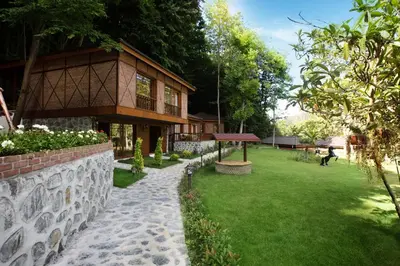 a house with a stone wall and a green yard at Casa Giallo Managed By Dedeman in Sapanca
