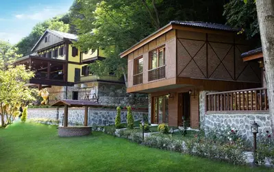 a house with a green lawn in front of it at Casa Giallo Managed By Dedeman in Sapanca