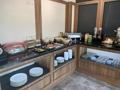 a kitchen with a counter with white dishes on it at Fidanoğlu Suite Hotel Çorlu in Corlu